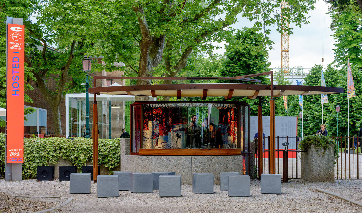 Historic Ticket Office designed by Carlo Scarpa positioned at the entrance of the Venice Biennale with people inside.